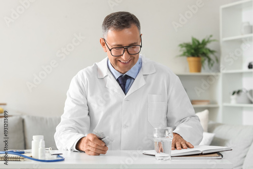 Mature doctor with pills vi...