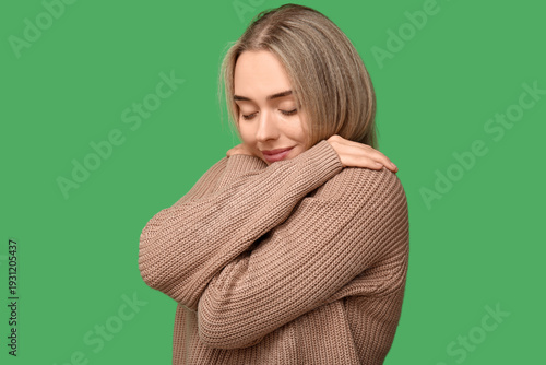 Young woman embracing herse...