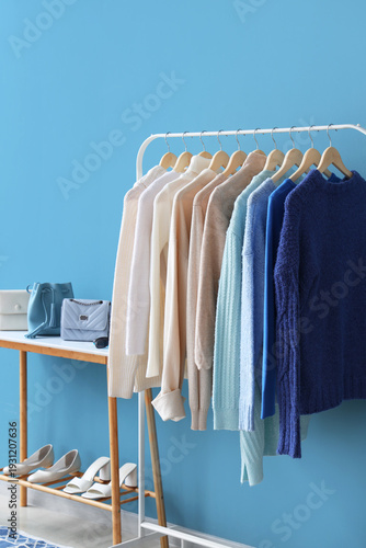 Rack with stylish clothes, ...