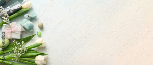 Easter eggs with flowers, gift boxes and bunny on grunge blue background
