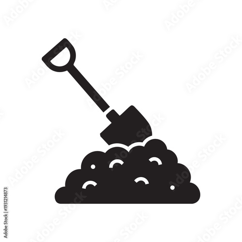 A shovel digging into a pile of dirt