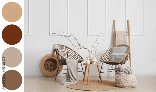 Vases with tree branches and Easter eggs on table and wicker armchairs in light living room. Different color patterns