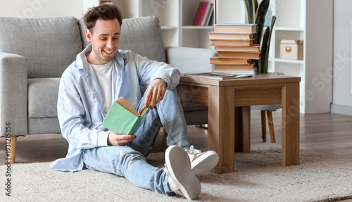 Young man reading book on f...