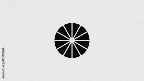 Black circular graphic element with radial lines viewed from directly above in a simple composition