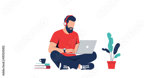 Young man sitting cross legged while working on laptop and wearing headphones in a relaxed home office environment.
