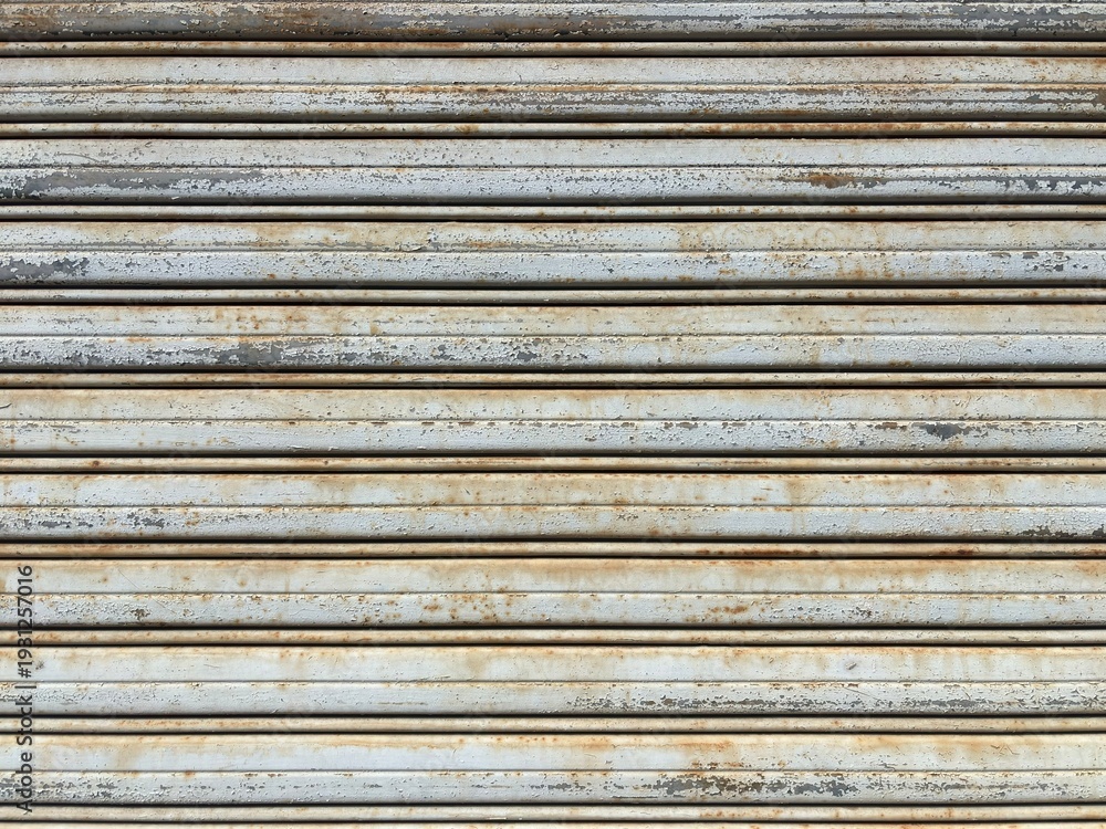 Fototapeta premium Weathered metal shutter texture with rust and peeling paint background