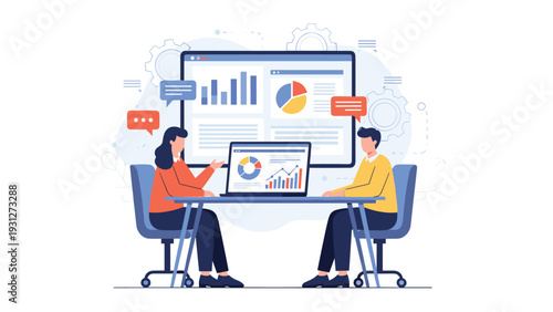 Professional colleagues sitting at a table discussing data visualizations on a laptop and large monitor.