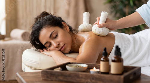 Traditional Ayurvedic Pindasweda massage therapy with warm herbal pouches in luxury spa wellness center