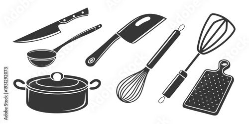 A variety of kitchen utensils and tools arranged on a flat surface