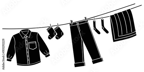 Clothes hanging on a clothesline with clothespins in a black and white image