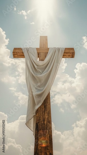 Serene symbolism of the cross against a cloudy sky with divine light