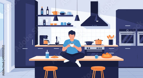 Relaxed man sitting cross legged on a kitchen island drinking a cup of hot coffee in a modern dark blue kitchen with sleek appliances.