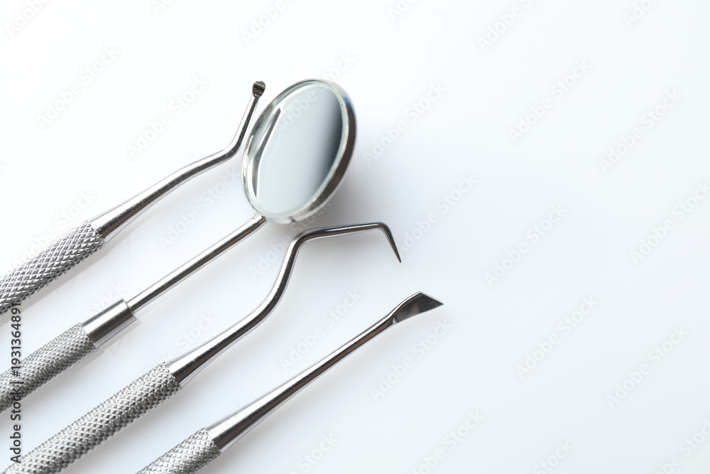 Fototapeta premium Different dental tools on white table, closeup. Space for text