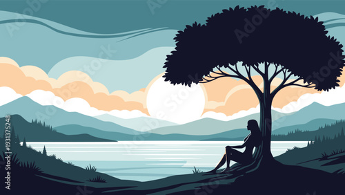 Peaceful sunset landscape shows the silhouette of a woman resting under a large tree while looking at a calm lake and distant mountains.