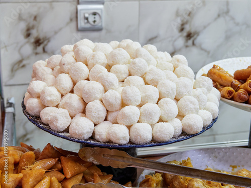 Moroccan street food stalls. Couscous, pastilla, traditional sweets, bread, tahini, colorful spices