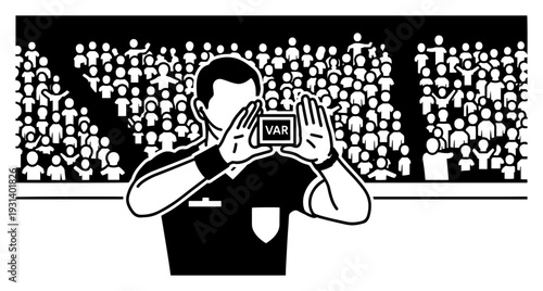 Football referee making the VAR signal in front of a cheering stadium crowd