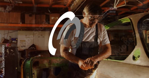 Mechanic starting grinder grinding panel for repair sparks flying while arcs growing over panel