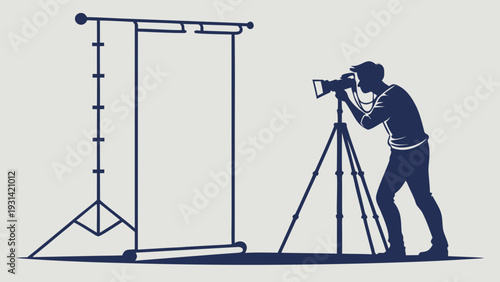 Photographer capturing images in a studio setting with a backdrop.