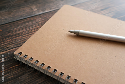Spiral Notebook and Pen on Wooden Desk – Minimal Workspace Background