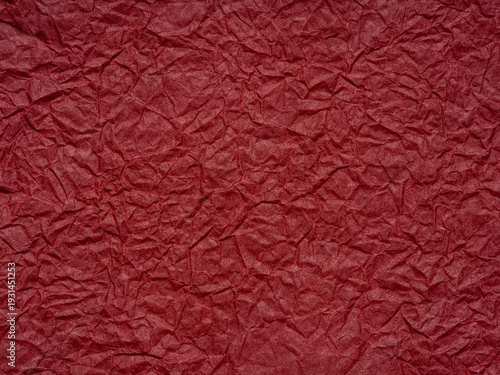 Red crumpled paper texture. Blank dark page pattern for winter season Christmas festival card, new year designs decoration, background concepts, text, lettering, wall screen saver or other art work.