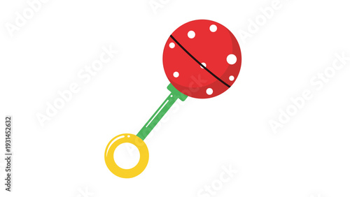 Bright red baby rattle toy with white polka dots and a green handle ending in a yellow ring isolated on a white background.