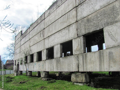Abandoned unfinished concrete industrial building and factory ruins