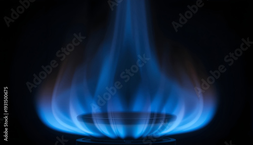 Blue flame burning from a gas stove burner against a dark background, showcasing the vibrant colors and patterns of the flame in a close-up view