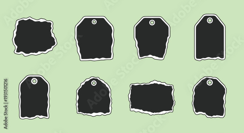 Collection of black t-shirts with labels.