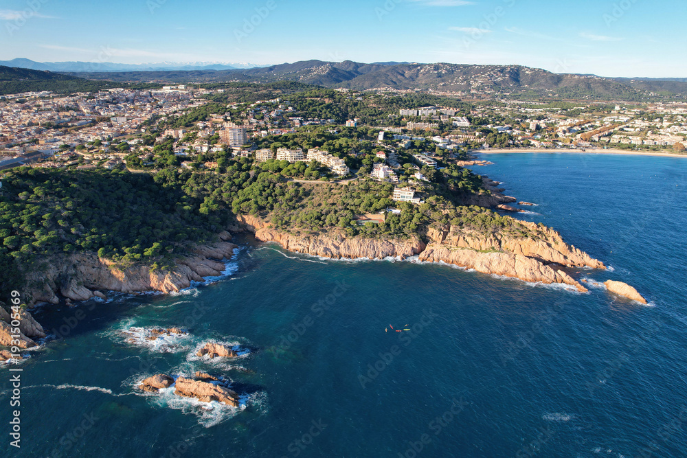 Fototapeta premium Aerial view of Sant Feliu de Guíxols and Mediterranean coastline on sunny day. Girona, Spain.
