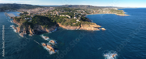Panoramic aerial view of Sant Feliu de Guíxols and Via Ferrata Cala del Molí on sunny day. Girona, Spain.