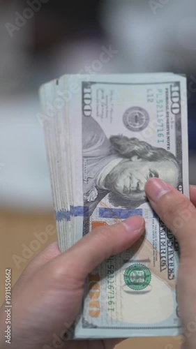 Female hands counting dollar banknotes sitting in room at table. Banking and finance. Business lifestyle. Rich woman hands holding cash money in bank cabinet. Financial job concept. Close up shot