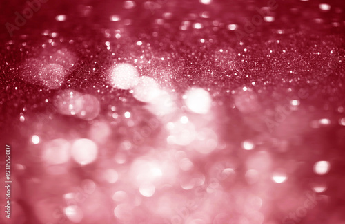 Pink, red white glittering Christmas lights. Blurred abstract bokeh background.