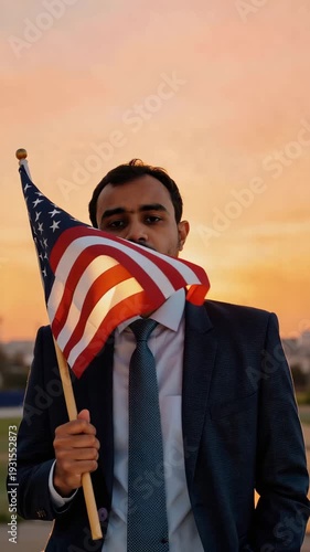 Man in Suit Holding American Flag Covering Face at Sunset