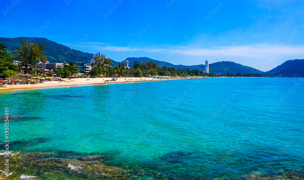 Naklejka premium Tropical Patong Kamala Beach Phuket Thailand tourists people parasol palm.