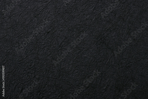 黒い和紙の質感がある和風の背景テクスチャ素材　Black washi paper texture background and Japanese style material
