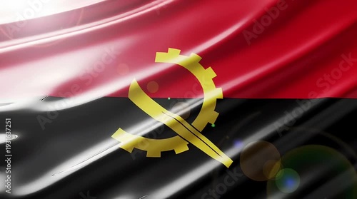 Close-up view of the waving national flag of Angola with a glossy texture and lens flare.