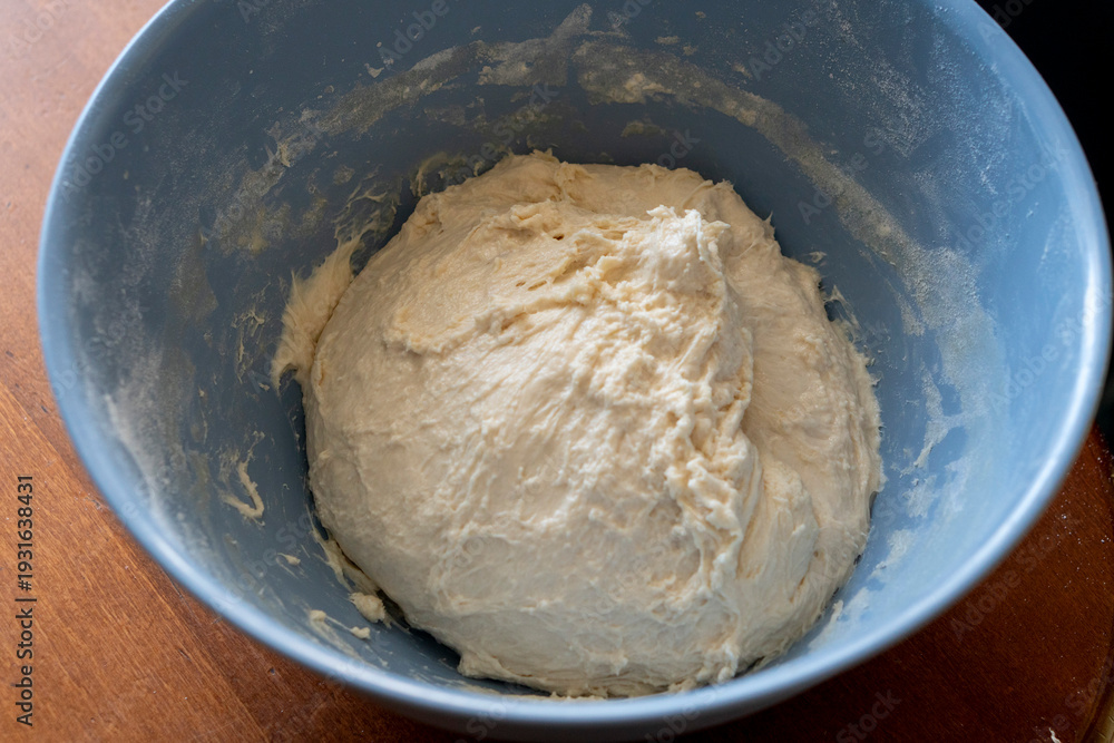 Fototapeta premium Close-up of hands stuffing raw dough with minced meat for traditional pies