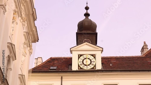 Vienna, Austria - April 10th 2025: Old fashioned clock tower on top of Vienna building