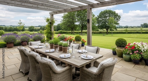 Outdoor dining table setting on patio with garden view and summer plants