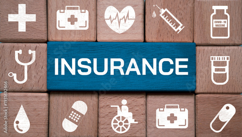 Health insurance concept with wooden blocks and medical icons including cross, heart rate, syringe, vaccine, wheelchair and stethoscope for healthcare coverage, medical protection and policy planning.