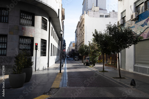 A quiet Buenos Aires street, wide-angle, eye-level. 