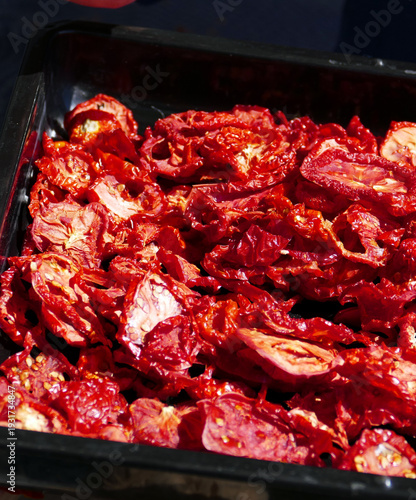 drying tomatoes in the sun, finely chopped tomatoes are dried on the balcony,