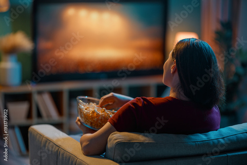 Woman Relaxing at Home Watching TV with Popcorn