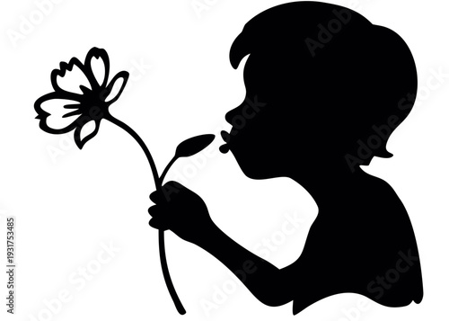 Little boy smelling a flower in a charming moment