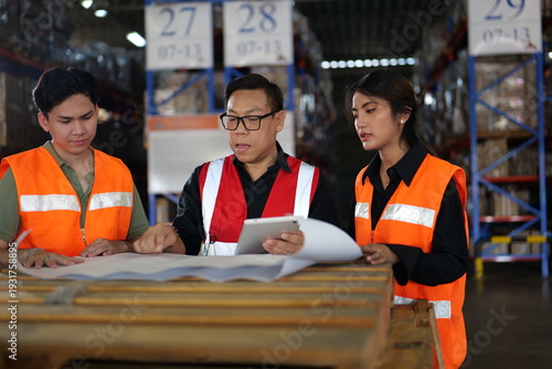 Asian male warehouse supervisor is holding a team meeting, assigning tasks to male and female workers in sorting area to ensure the goods are delivered to customers in a accurate manner on schedule.
