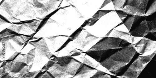 A black and white abstract close-up of a crumpled and wrinkled paper surface with high contrast