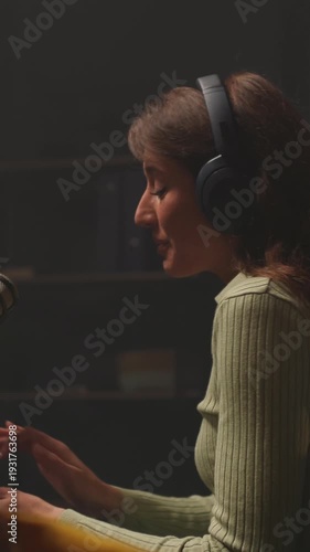 Woman hosting podcast with microphone, Host alternating between interviewer and storyteller in studio setting