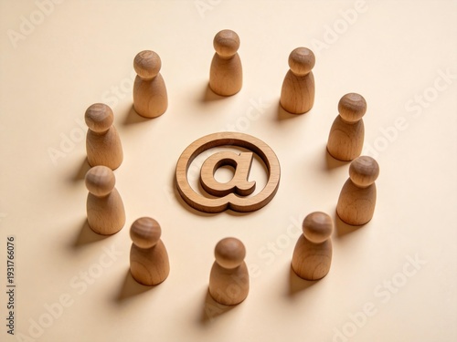 EmailSymbolSurroundedByWoodenFigures