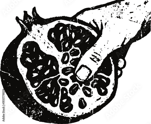 Hand holding a sliced pomegranate fruit showing seeds texture and juicy segments