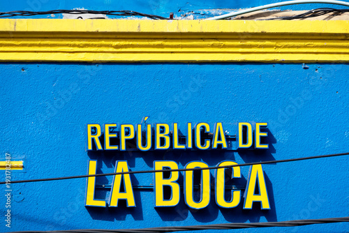 Vibrant blue wall with yellow trim. 